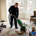 Technician cleaning carpet in Glasgow living room